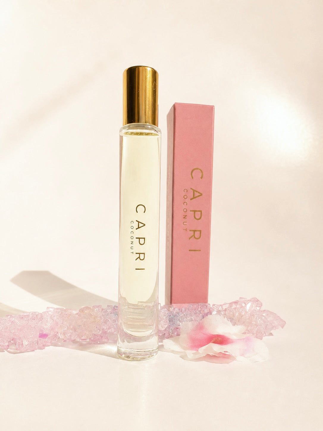 Capri perfume bottle with pink packaging on a light background